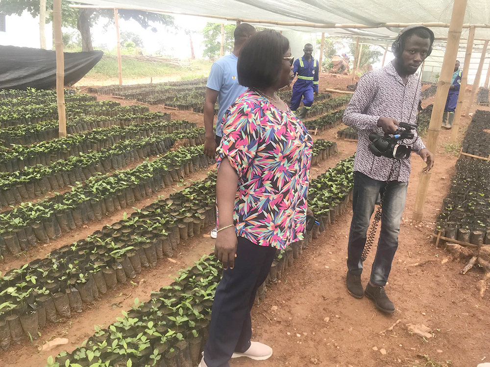 Faustine Asamany touring one of the seed production gardens in Apedwa with journalists 